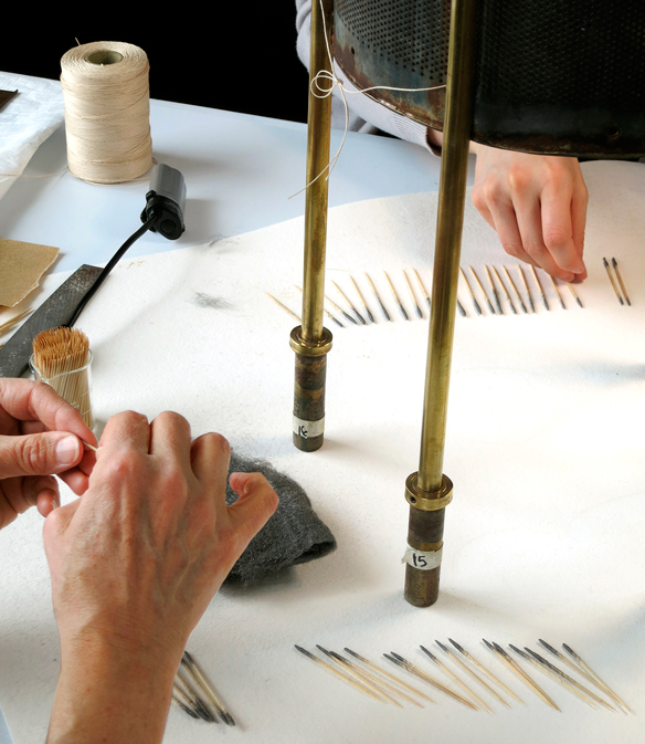 Conservators make swab-like tools out of steel wool and toothpicks to clean corrosion.