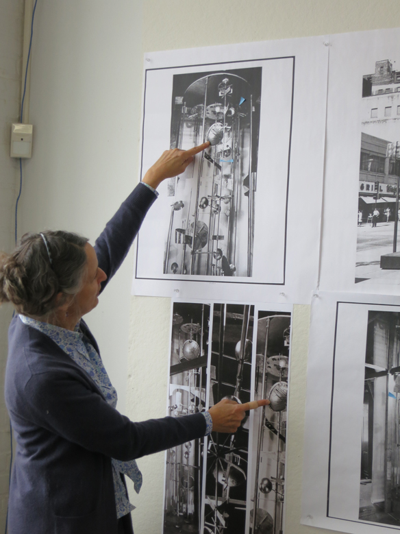 Kristin Cheronis examining historic photos of the Sculpture Clock.