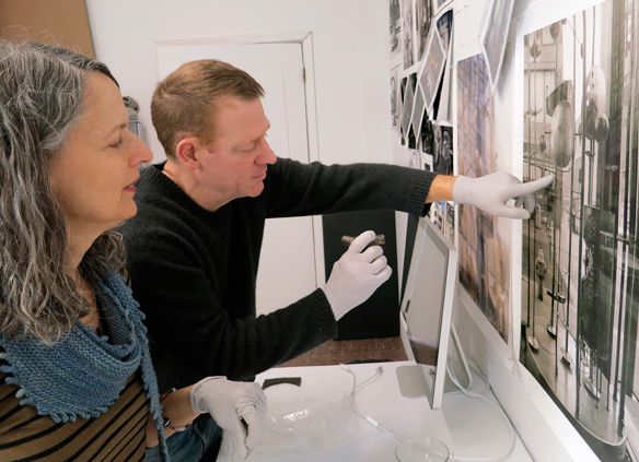 Cheronis and Cora examinging historic photographs.